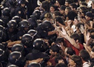 People violently protesting against the exorbitant cost of Pope Benedict XVI visit to Madrid