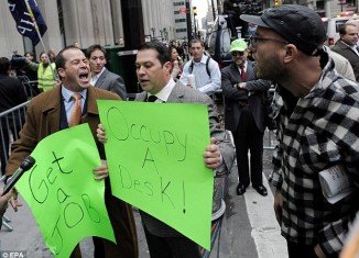 Derek and John Tabacco, two brothers who work in the financial district, stood next to the Occupy protesters holding up signs reading "Get a job" and "Occupy a Desk", before others joined them