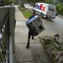 FedEx delivery man caught throwing a computer monitor over a fence