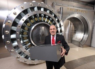 Muhtar Kent, Coca-Cola Company CEO, is placing a metal box, which the company says contains the formula, inside a five-foot high safe