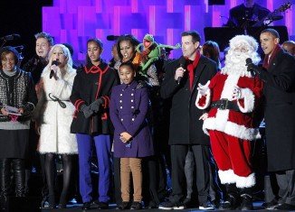 President Barack Obama, First Lady Michelle Obama, and their daughters Sasha and Malia took the stage next to Santa Claus and Kermit the Frog and officially marked the start of the Christmas season