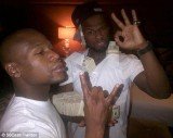 50 Cent has showed off his money literally in a series of vulgar poses on his Twitter page