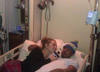 Mariah Carey, 41, bizarrely posted a photo of herself posing beside an ailing Nick Cannon, 31, in his hospital bed