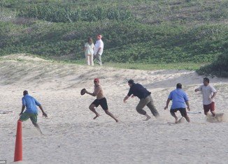 President Barack Obama stripped off for some beach football to round off his Christmas holidays in Hawaii