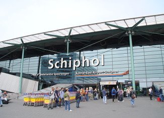 Amsterdam's Schiphol airport has been evacuated after Dutch police has arrested a man who locked himself in a toilet and claimed to have a bomb