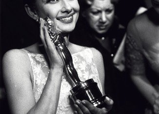 Audrey Hepburn grins and sports an elfin haircut while clutching her Oscar in 1953, for her breakout role in Roman Holiday alongside Gregory Peck
