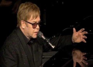 Elton John said his shows in Las Vegas were cut because he was sick with food poisoning, not because he was attending Whitney Houston’s funeral