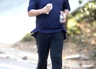 Kiss rocker Gene Simmons looked strangely taut as he jogged in Studio City yesterday with his family