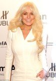 Lindsay Lohan looked years older than her quarter of a century, as she appeared on the red carpet sporting a matronly look, and heavy make-up for the stylish affair last night