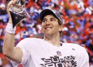 New York Giants quarterback Eli Manning poses with the Vince Lombardi Trophy after the Giants defeated the New England Patriots by a score of 21-17 in Super Bowl XLVI at Lucas Oil Stadium