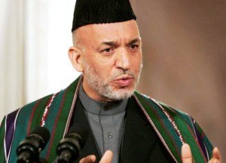Afghan President Hamid Karzai accuses the US of not fully co-operating with a probe into the Kandahar massacre of 16 civilians by an American soldier