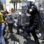 Athens clashes between protesters and riot police after pensioner suicide beside parliament