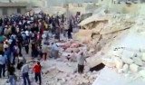Syrian activists say at least 70 people have been killed in an attack on a house in Hama