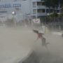 Girl blown by a plane on Maho Beach in St. Maarten
