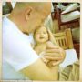 Bruce Willis cuddling newborn daughter Mabel Ray in his arms