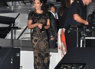 Kim Kardashian poured her ample curves into a stunning lace outfit which consisted of a crop top and matching maxi skirt