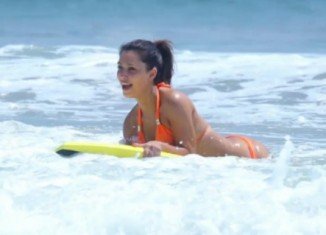 Kim Kardashian sporting a halterneck orange bikini as she hit Mexico beach with sister Kourtney and nephew Mason