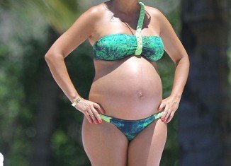 Kourtney Kardashian flaunted her very large baby bump in a bright green bikini during a recent trip to Mexico to celebrate her 33rd birthday