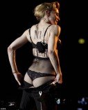 Madonna stripped off her microphone pack and unbuttoned her trousers, turned round, pulled them down and flashed her G-string clad derriere to the audience at the Stadio Olimpico in Rome
