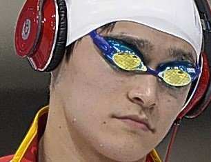 A number of Olympic swimmers at London Games are walking out to the pool wearing headphones