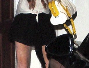 Lindsay Lohan revealed blotchy fake tan and bruised legs as she spent a night off at the Chateau Marmont in Hollywood
