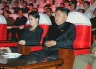 One picture taken during the performances showed the mystery woman with her hand on the armrest of Kim Jong-Un's chair