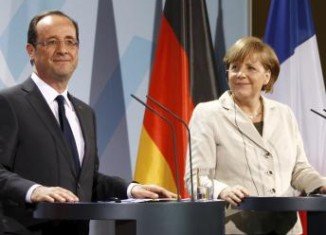Angela Merkel and Francois Hollande are set to hold talks in Berlin on whether to give Greece more time to make the cuts required by its debt bailout
