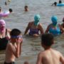 Chinese beach-goers wear nylon masks to keep off blazing sun