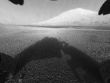 Curiosity rover on Mars has returned black and white images that capture part of its own body, its shadow on the ground and views off to the horizon
