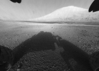 Curiosity rover on Mars has returned black and white images that capture part of its own body, its shadow on the ground and views off to the horizon