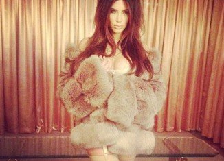 Kim Kardashian posed for a steamy photo shoot wearing nothing more than stockings, lingerie and a fur coat
