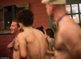 Mark Zuckerberg caressing his hairy chest while obviously having a very good time cavorting with the other topless men