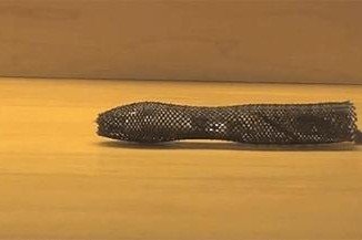 Meshworm is a robot that mimics a worm's movements, crawling along surfaces by contracting segments of its body