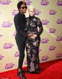Amber Rose put a tender hand on her growing stomach as she joined fiancé, rapper Wiz Khalifa, on the red carpet at 2012 MTV VMAs