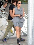 Kim Kardashian covered her famously curvaceous figure in a grey sleeveless “skorts-suit” while shopping in Miami Beach