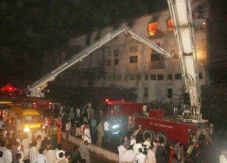 More than 200 people are now known to have died in a fire at a garment factory in Karachi