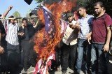 Palestinians burn a US flag during a protest against the movie, Innocence of Muslims, near the UN office in Gaza City
