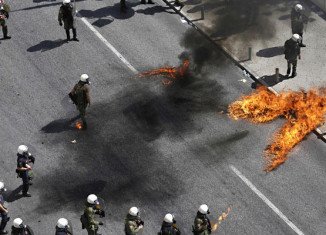 Police have fired tear gas in Greece to disperse anarchists throwing petrol bombs near parliament in Athens