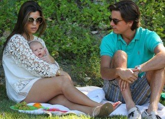 Scott Disick and Kourtney Kardashian covered their baby daughter Penelope in kisses as they took her to the park for a picnic