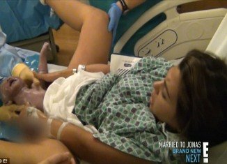 The Kardashians were all inside the delivery room to see Kourtney pulling the little girl out with her hands
