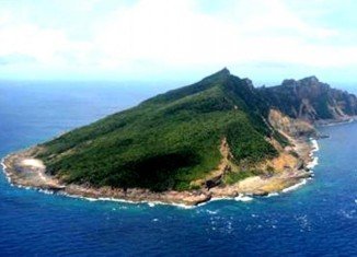 Two Chinese patrol ships have been sent to islands disputed with Japan, which has sealed a deal to purchase the islands