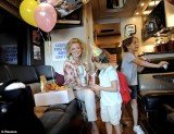 Ann Romney is campaigning for her husband on a bus tour through the swing state with her two grandsons, Parker and Miles