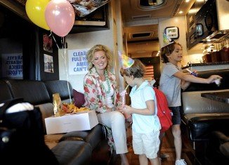 Ann Romney is campaigning for her husband on a bus tour through the swing state with her two grandsons, Parker and Miles