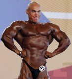 Bodybuilder’s head literally paled in comparison to his super-bronzed body as he flexed his muscles for the judges