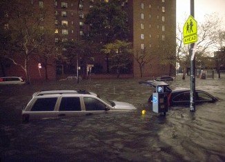 Cars were swept down streets and power was cut across lower Manhattan in a bid to minimize damage to infrastructure