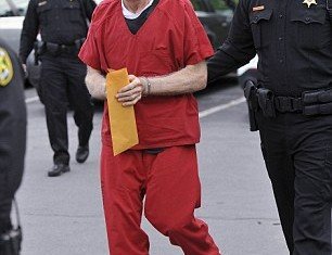Flanked by sheriff's deputies, Jerry Sandusky's bullet-proof vest can visibly be seen under his jumpsuit