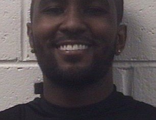A newly-released booking photo of Nick Gordon shows him smiling following his arrest for reckless driving