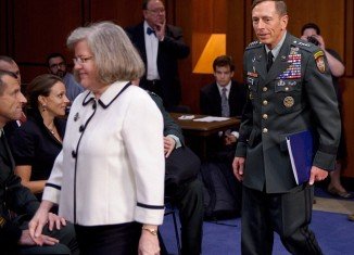 Paula Broadwell was caught gazing at David Petraeus as he entered a congressional hearing with his wife Holly in a photograph from 2011