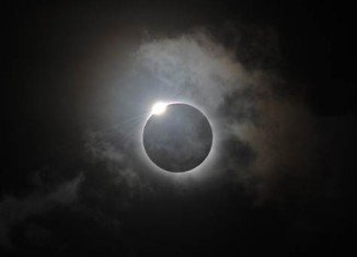 Tens of thousands of tourists and astronomers gathered in Queensland, northern Australia, to glimpse a rare total solar eclipse