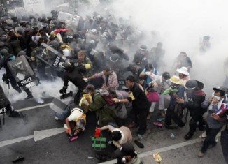 Thai police have used tear gas against thousands of protesters calling for the overthrow of Prime Minister Yingluck Shinawatra in Bangkok